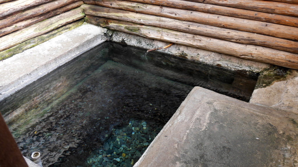 The pool was made out of concrete with stones on the bottom