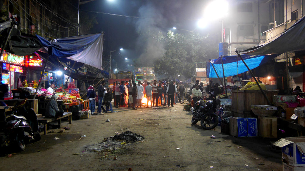 People gathered around the fire at Bara Bazar