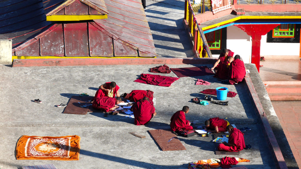 Young monks drawing on the roof