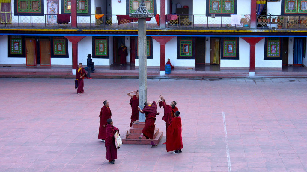 Monks playing a game with a coin