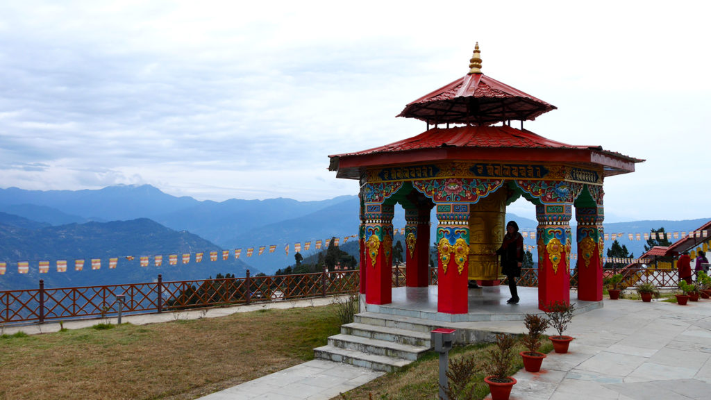 There were big prayer wheels next to the statue