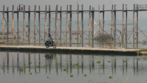 Seri riding motorbike next to the U Bein Bridge